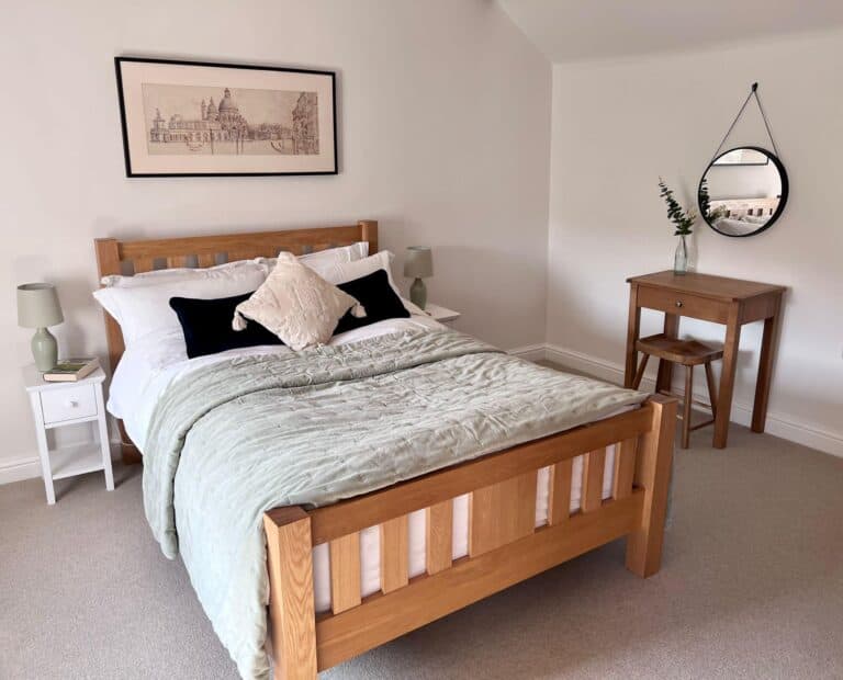 cottage bedroom with green throw