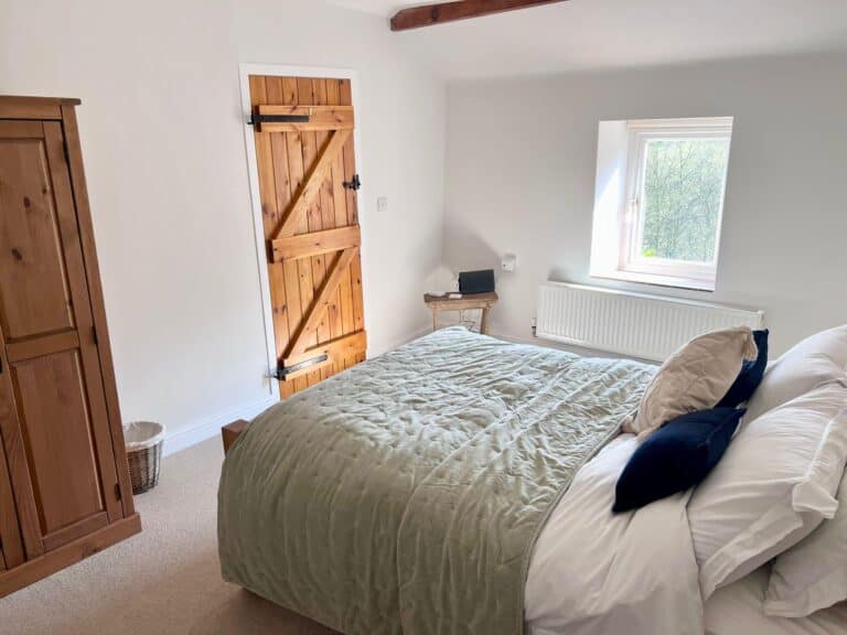 cottage bedroom with green throw